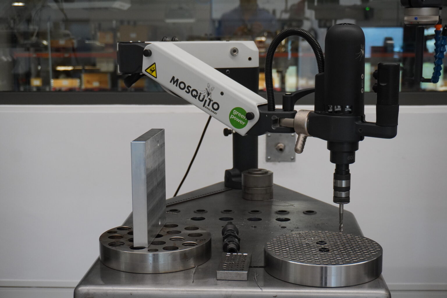 Robotic arm and digital control system at a workstation equipped with high-speed Roscamat industrial threading machines.